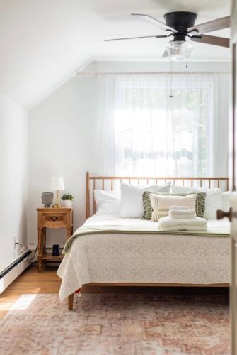 a bedroom with a bed with a ceiling fan at Catskill Cabin with Firepit & Brilliant Fall Views in Catskill
