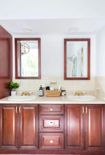 a bathroom with two sinks and two mirrors at Catskill Cabin with Firepit & Brilliant Fall Views in Catskill