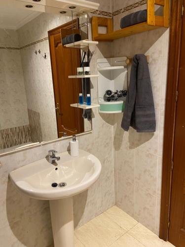 a bathroom with a sink and a mirror at Casa Estribor, vacaciones en ambiente familiar in Punta de Mujeres