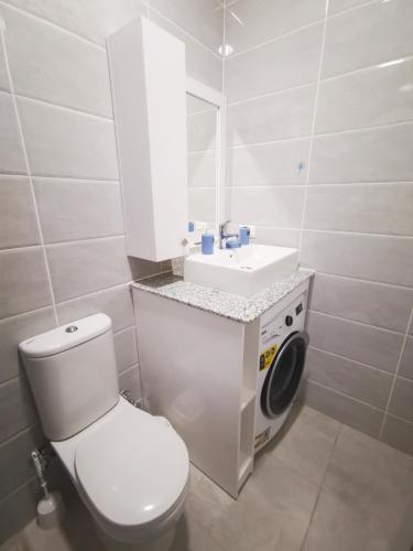 a white bathroom with a toilet and a sink at Loft VIP in Naama bey in Sharm El Sheikh