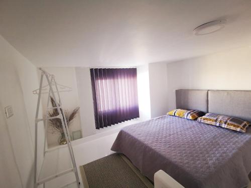 a bedroom with a bed and a ladder and a window at Loft VIP in Naama bey in Sharm El Sheikh