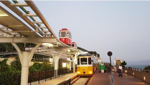a train is pulling into a train station at Haeundae Mipo House1 in Busan