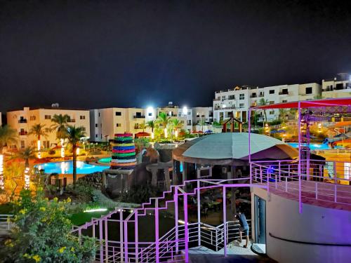 a view of a resort with a pool at night at Loft VIP in Naama bey in Sharm El Sheikh