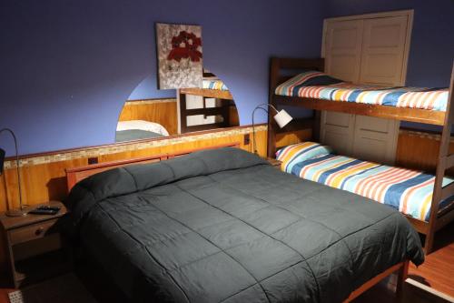 a bedroom with two bunk beds and a mirror at Hostal Valle Central San Fernando, Chile in San Fernando