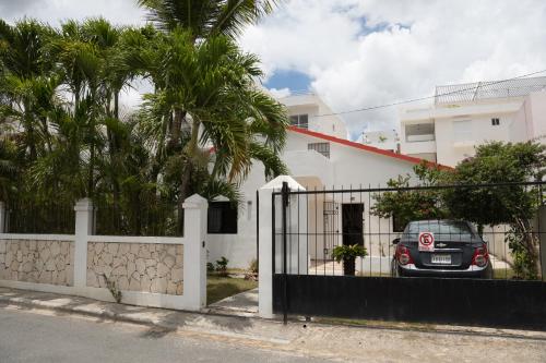 a car parked in front of a white house at Villa Rosandri in Bayahibe