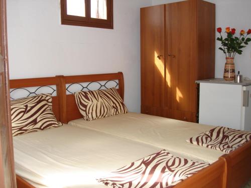 a bed with zebra pillows in a bedroom at Villa Elena in Líndos