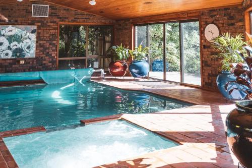 a swimming pool in a house with a pool at High Grange Luxury Mountain Retreat - Pool, Spa, Sauna in Kalorama