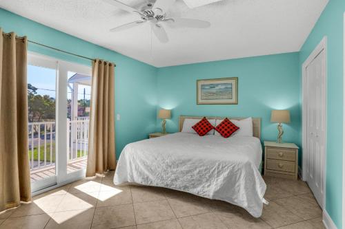 a bedroom with a bed and a balcony at Seabreeze Escape in Destin