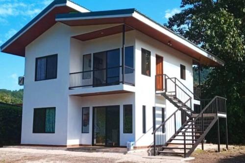 a house with a staircase in front of it at Villa Marina, Nosara in Nosara
