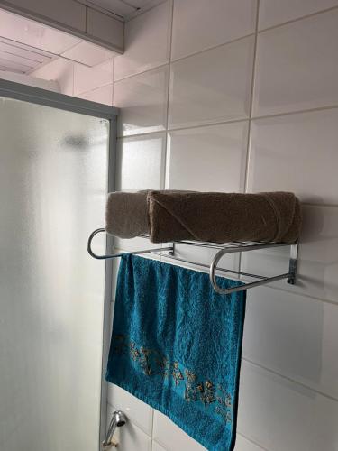 a towel rack with two towels on it in a bathroom at Loft no centro de Joinville in Joinville