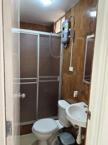 a bathroom with a shower and a toilet and a sink at Morada in Tacna