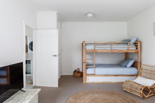 a room with two bunk beds and a tv at Saltwood in Bridport