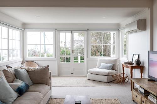 a living room with a couch and a tv at Saltwood in Bridport