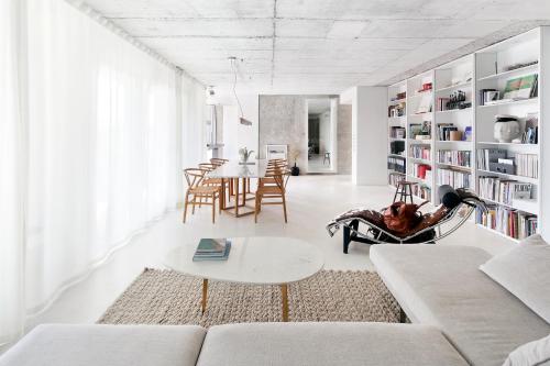 a living room with a couch and a table at Loft River Lisbon -with garage in Lisbon