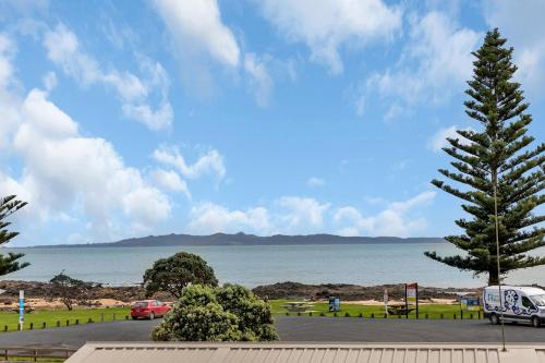 a view of the ocean from a parking lot at Seaside on Stratford - Cable Bay Holiday Home in Cable Bay
