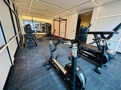 a gym with several treadmills and machines in a room at La Carolina - Studio de lujo in Quito