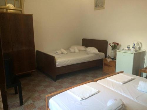 a small bedroom with a bed and a dresser at Villa Elena in Líndos