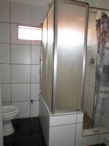 a bathroom with a shower and a toilet at Mokopane at Freedom City Lodge in Mokopane