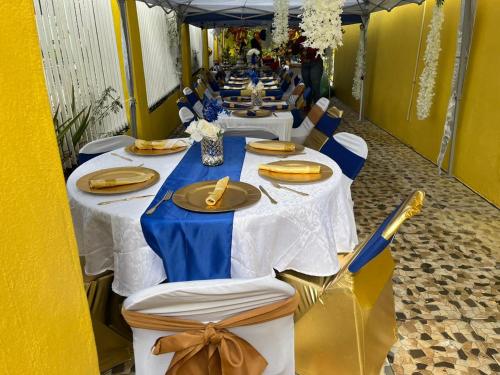 a row of tables with blue and white table cloths at LEO VILLA in Wallen