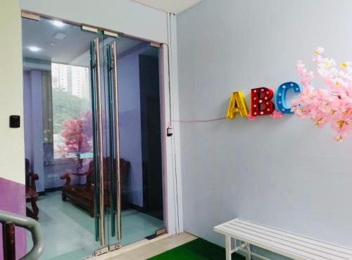 a sliding glass door in a room with a bench at ABC Hostel in Seri Kembangan