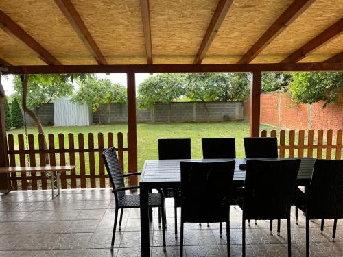 a dining table and chairs on a patio at ALOM in Osijek