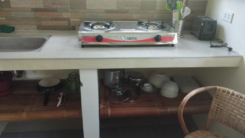 a stove sitting on top of a kitchen counter at ACACIA'S Cottages mit Starlink Wifi in Mambajao