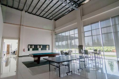a large room with a ping pong table and chairs at Sofias Place w/ Massagechair in Tagaytay