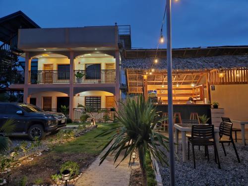a house with a car parked in front of it at Moalboal Cay in Moalboal