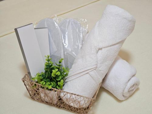 a basket of towels and a plant next to a towel at Moalboal Cay in Moalboal