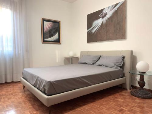 a bedroom with a bed and a painting on the wall at Mini Suite Cremona in Cremona