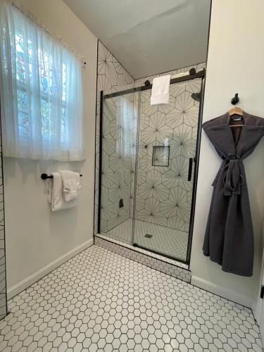 a shower with a glass door in a bathroom at Flora House Denver in Denver