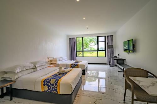 a hotel room with two beds and a table at Hotel Seoul in Clark