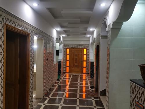 a hallway with a tile floor and a wooden door at Villa in Tamri Agadir in Agadir