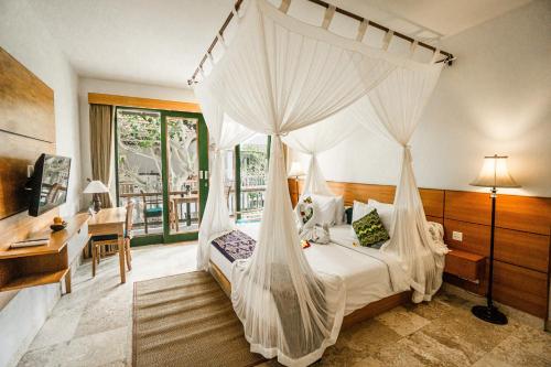 En eller flere senge i et værelse på Sabana Ubud