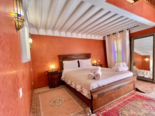 a bedroom with a bed with two towels on it at Riad Azad & Spa in Marrakesh