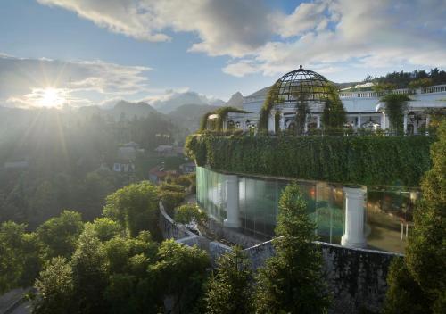a building with a garden on top of it at Silk Path Grand Sapa Resort & Spa in Sa Pa
