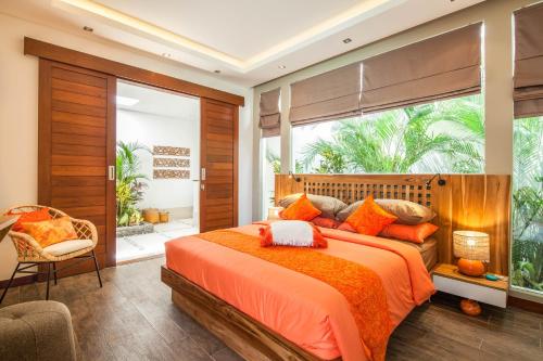 a bedroom with a large orange bed and a window at Dreamy 5br Haven, 200m To Berawa's Blissful Beach in Canggu