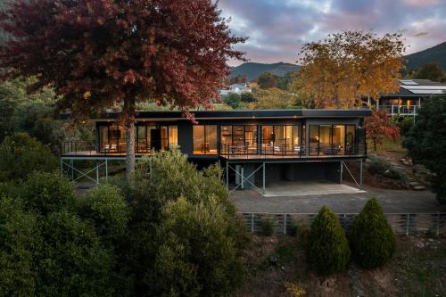 a house on a hill with a tree at The View Bright - Apartment 1 in Bright