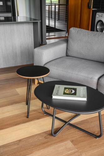 a living room with a couch and two tables at The View Bright - Apartment 1 in Bright