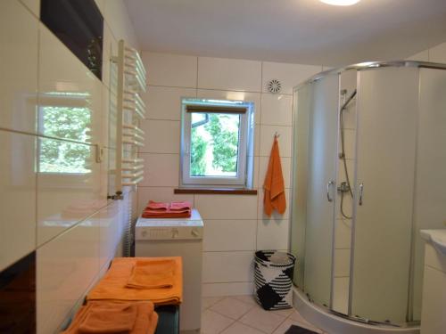 a bathroom with a shower and a washing machine at Spacious holiday home in Kopalino in Kopalino