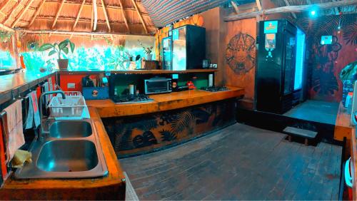 a kitchen with a sink and a counter top at Kin Hostal and Camping in Holbox Island