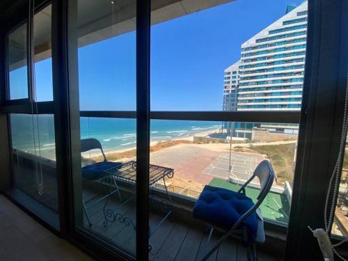 a view of the ocean from a balcony with chairs at ruth’s balcony sea view apt in Herzliya B