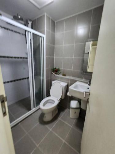 a bathroom with a toilet and a shower and a sink at 2 Bedrooms 2 bath Apartment in Chiang Mai