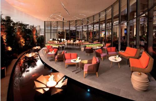 a restaurant with chairs and tables in a building at VDARA Beautiful suite on 22nd FLR Free Valet parking in Las Vegas