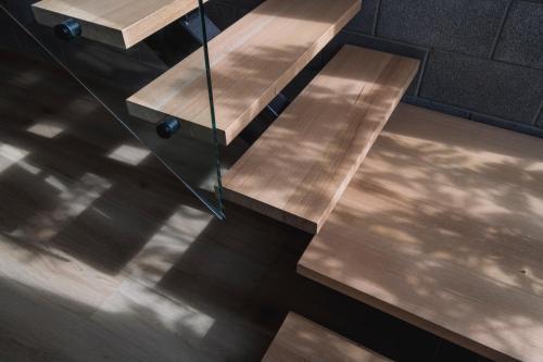 two wooden benches sitting on top of a wooden floor at Stadium View Townhouse in Geelong