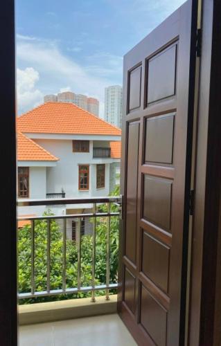 a door to a balcony with a view of a building at Hoa Sua Hotel in Vung Tau