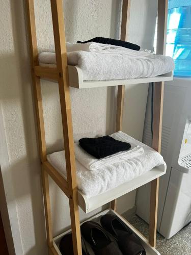a room with two bunk beds with white towels at The Beach Inn in Tanjung Bungah