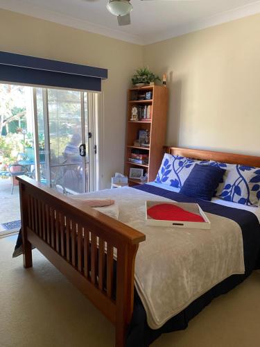 a bedroom with a bed and a sliding glass door at By the Bay Singles or Couples short stay private suite in Saint Leonards