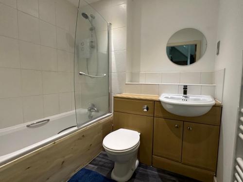 a bathroom with a toilet and a sink and a shower at Homestay with free wi-fi, parking and more in Darlington