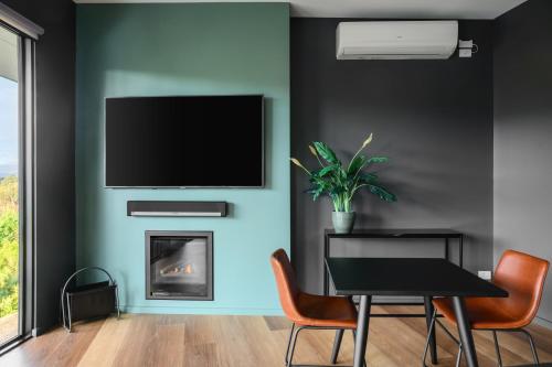 a dining room with a tv and a fireplace at The View Bright - Apartment 1 in Bright